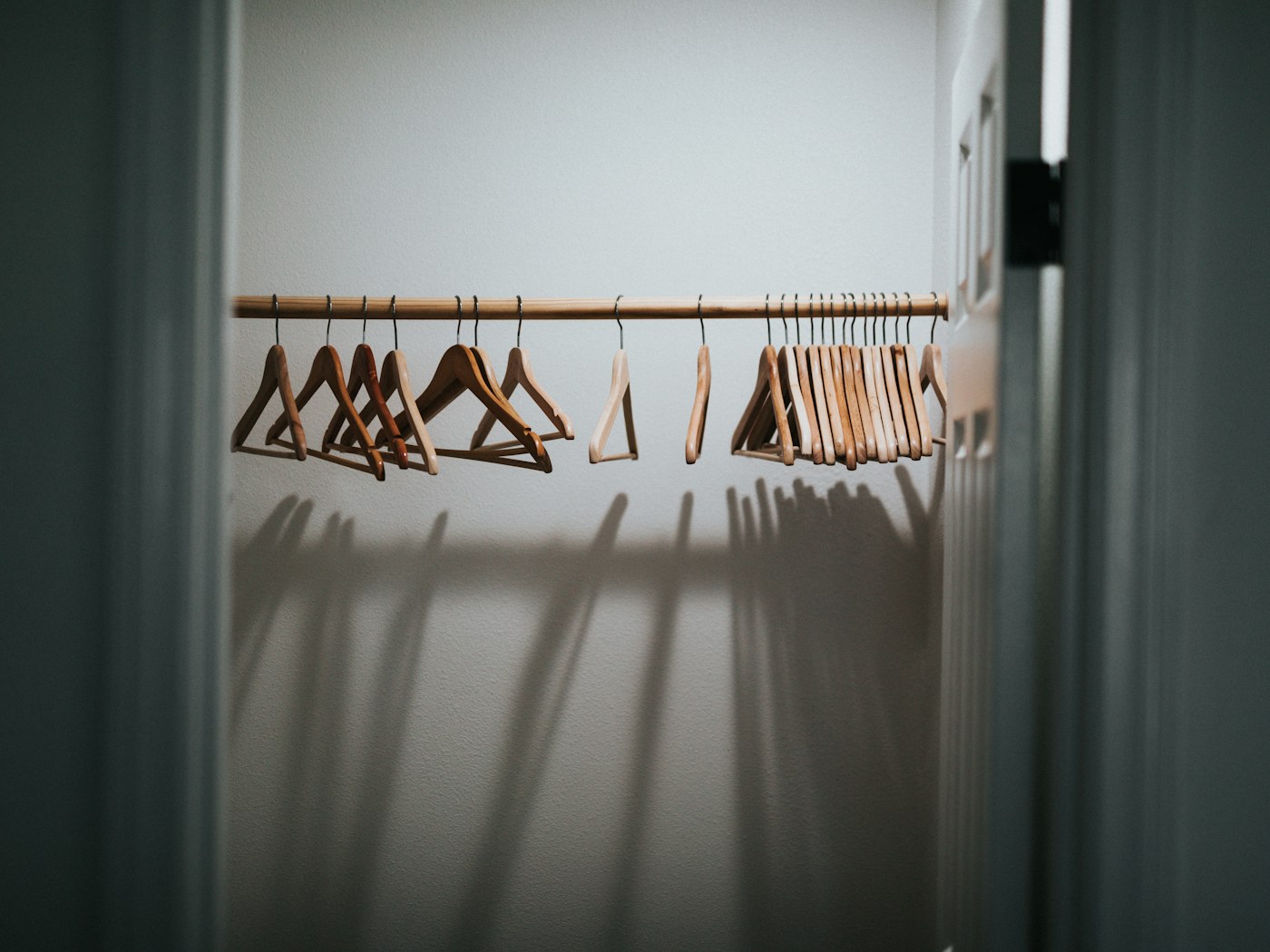 Organized wardrobe with shirts and jackets on coordinated hangers