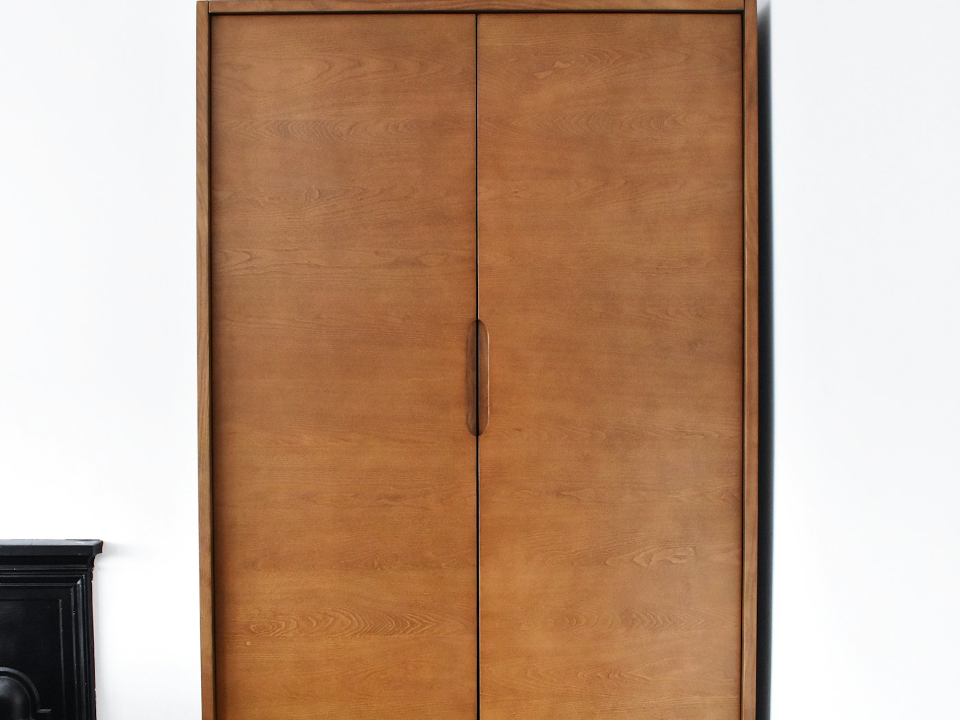 Wood kitchen drawer opened to organized utensils and cooking tools