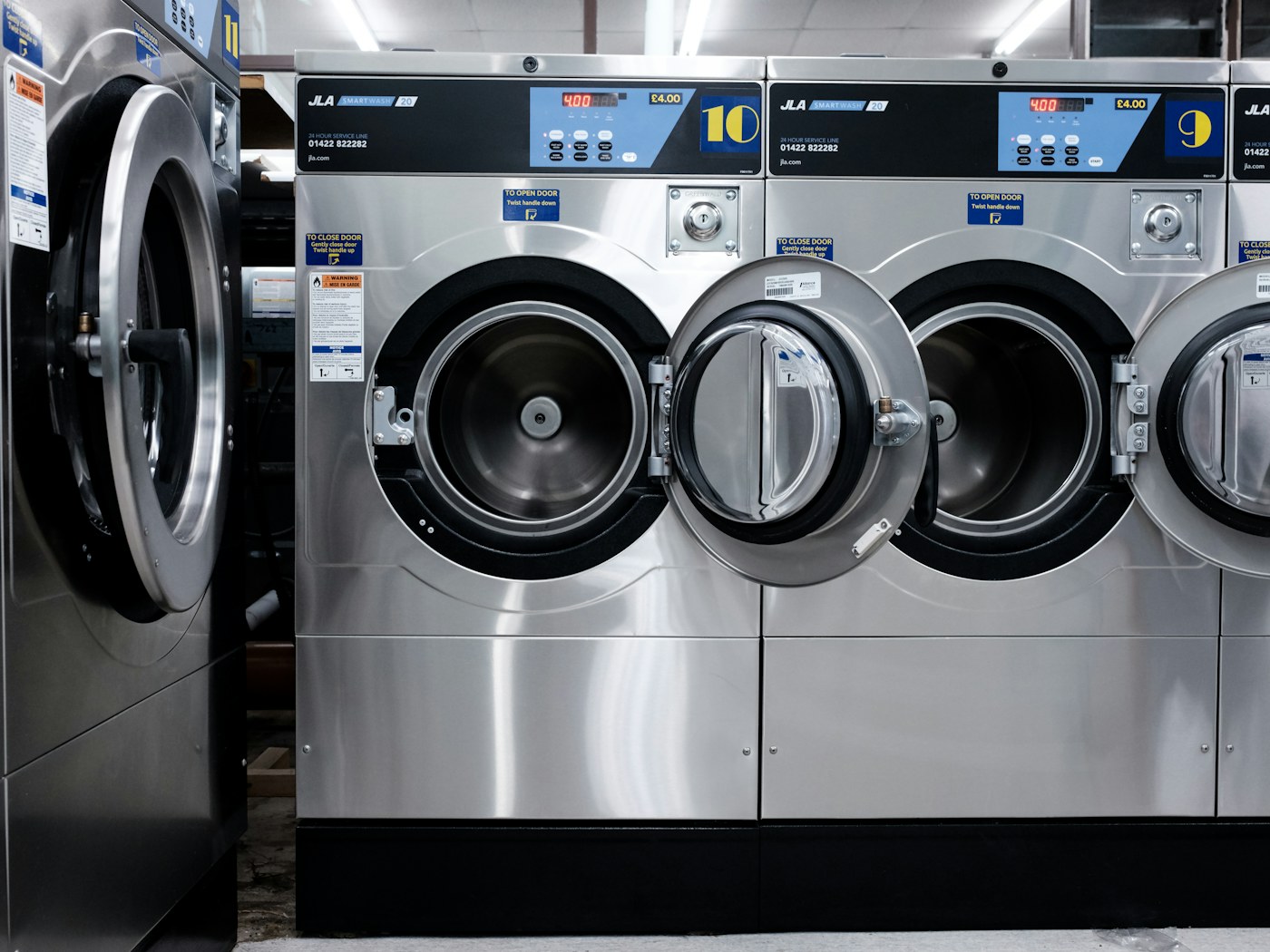 Compact laundry room with clothing drying on a foldable rack