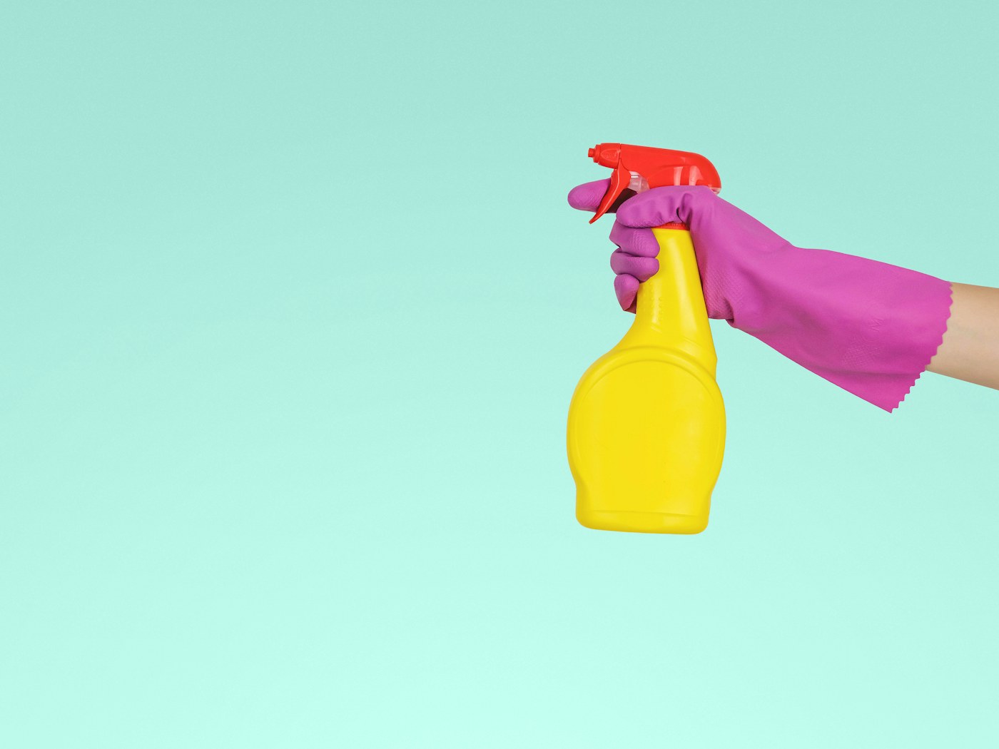 Hands wiping a kitchen counter with a microfiber cloth